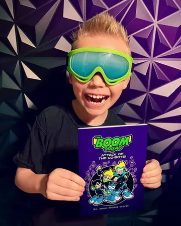 CJ in green goggles holding The Boom Squad book