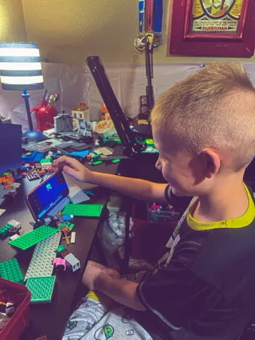 CJ checking a frame on his tablet surrounded by bricks