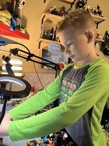 CJ setting up a shot under a ring light